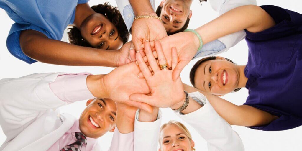Bird's eye view of people's hands stacked in the center